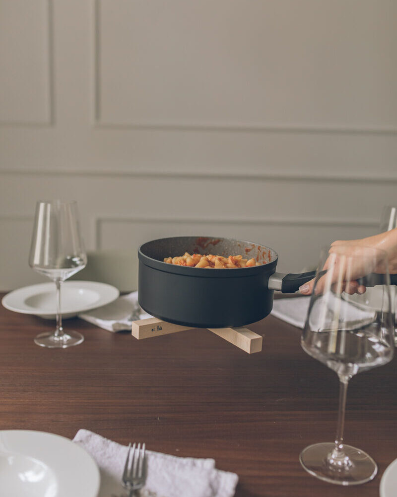 Pot on the trivet on a dining table