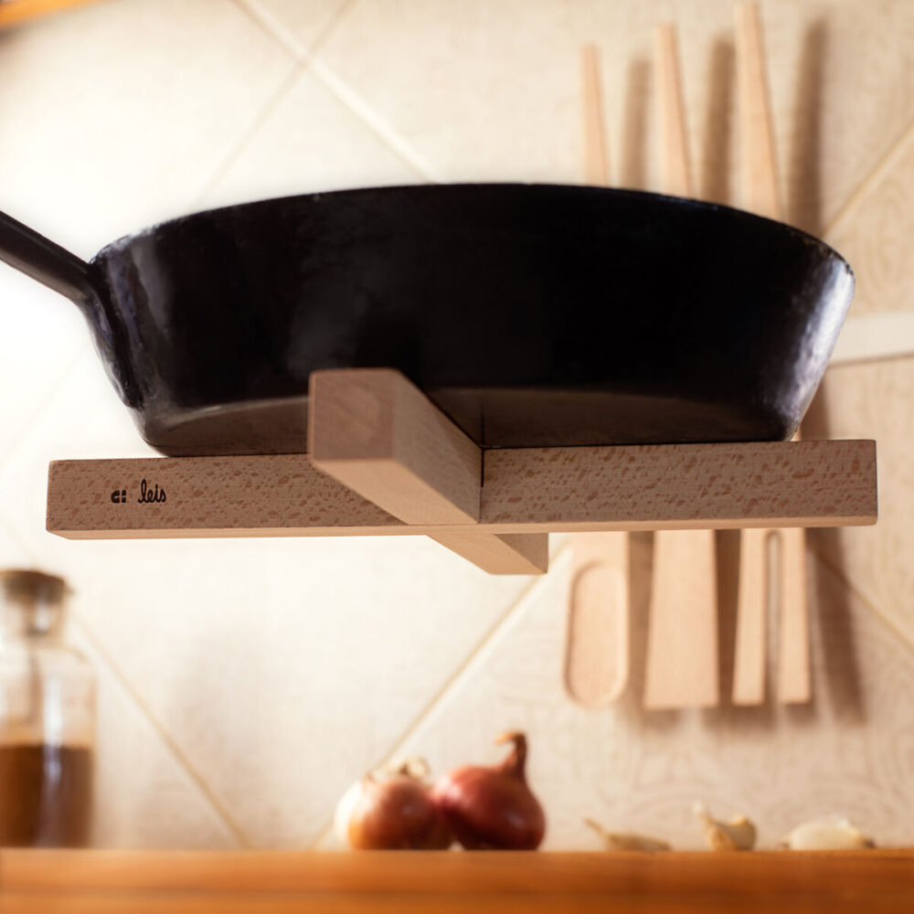 Pan hanging from a kitchen rail on the trivet